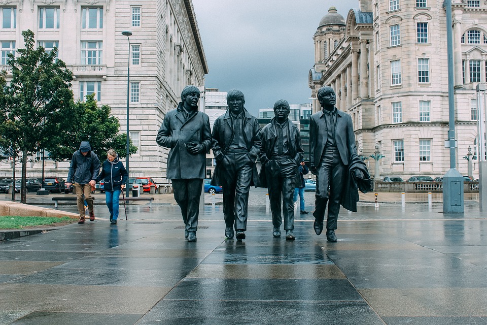 The Beatles Statue on the Liverpool waterfront in the rain, Liverpool, England, UK, United Kingdom